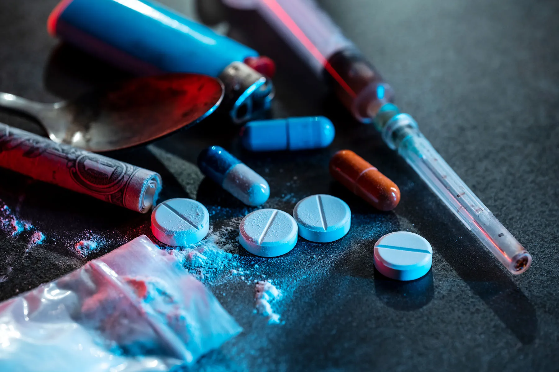 Drug abuse and cocaine addiction treatment at Nasha Mukti Kendra amravati- hand reaching for syringe and white powder